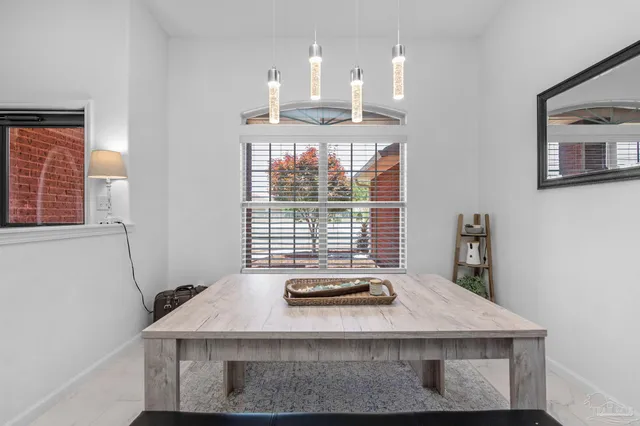 a view of a room with a table and chairs