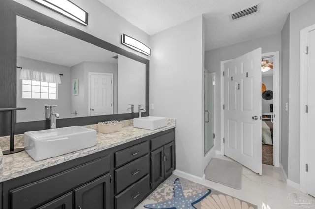 a bathroom with a glass shower door