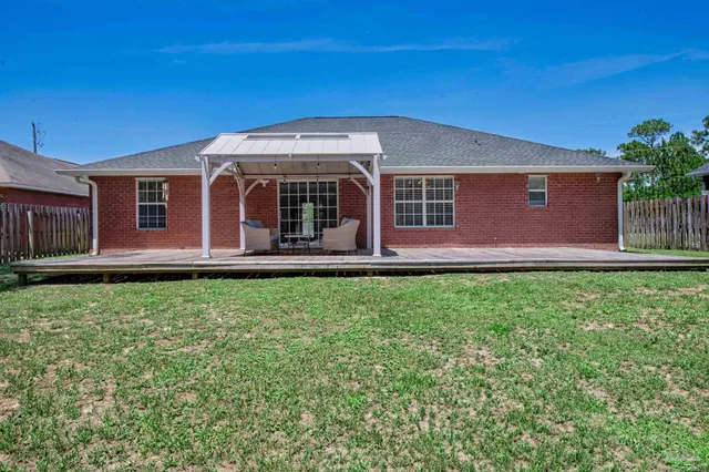 a view of a backyard with sitting area