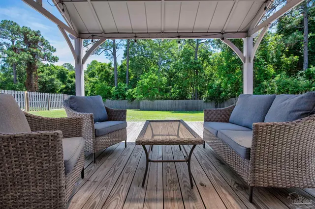 a view of a room with wooden floor and windows