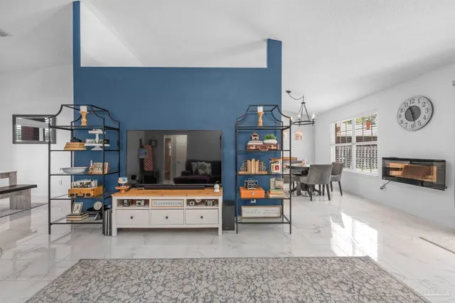 a living room with furniture and a dining table