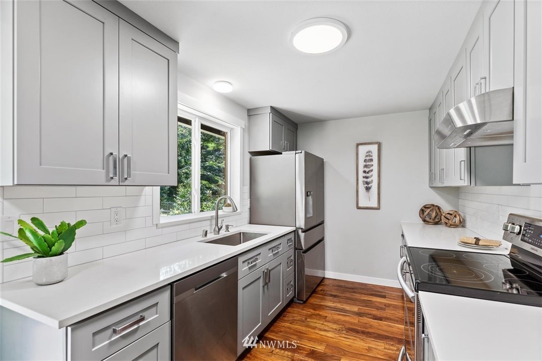 3422 192nd Street Southeast Bothell, WA 98012 - Photo 22 of 31 a kitchen with stainless steel appliances granite countertop a sink a stove and a refrigerator