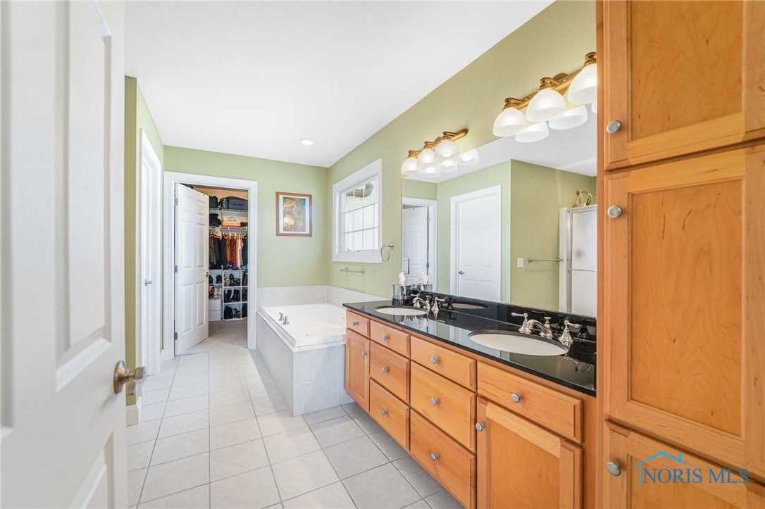 5841 Waterville Monclova Road Waterville, OH 43566 - Photo 25 of 39 The primary bath has beautiful cabinetry, a tub, separate shower, private lavatory, two (2) walk-in closets.