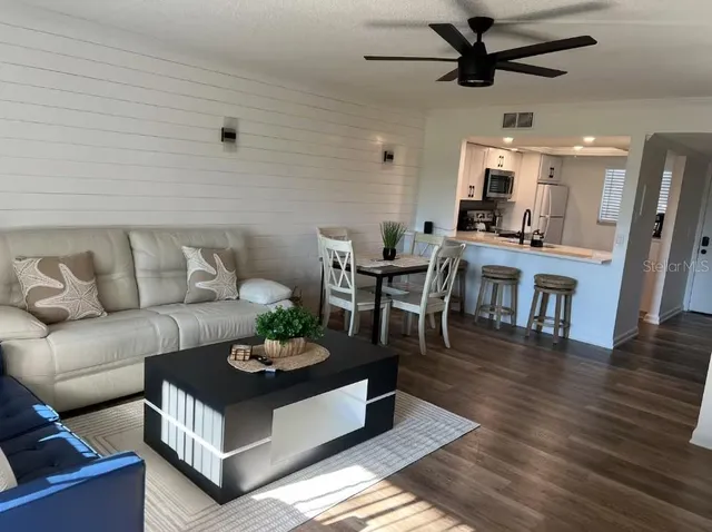a dining room with furniture and a floor to ceiling window