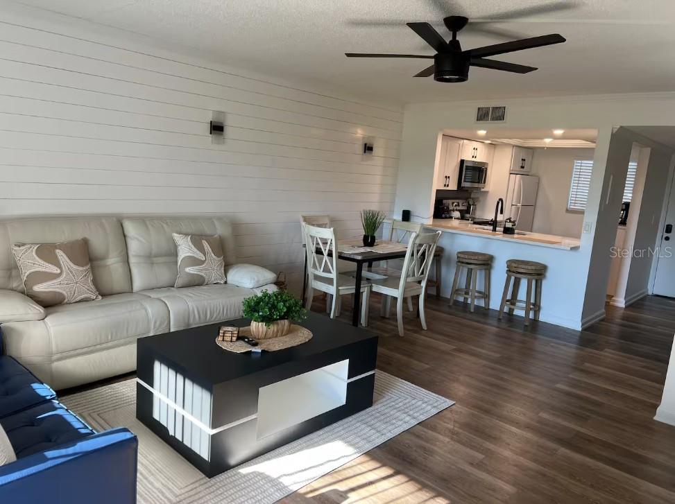 3700 South Beneva Road, Unit 604 Sarasota, FL 34232 - Photo 2 of 10 a living room with furniture a window and a table