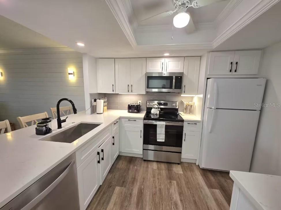 3700 South Beneva Road, Unit 604 Sarasota, FL 34232 - Photo 5 of 10 a kitchen with refrigerator a sink and cabinets