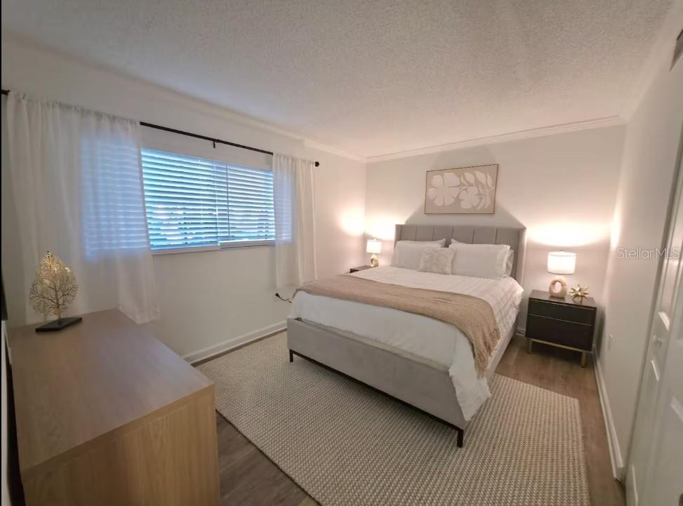3700 South Beneva Road, Unit 604 Sarasota, FL 34232 - Photo 6 of 10 a bedroom with a bed and a night stand