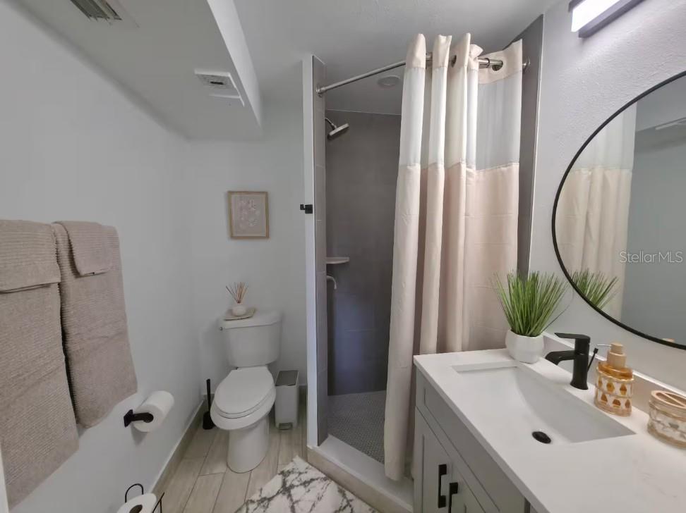 3700 South Beneva Road, Unit 604 Sarasota, FL 34232 - Photo 9 of 10 a bathroom with a sink toilet and shower