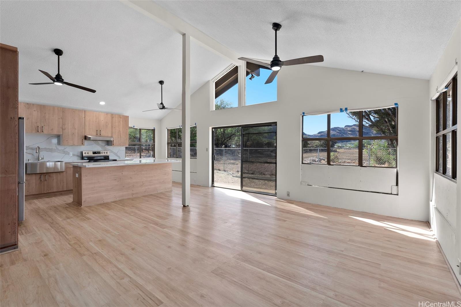87-1087 Apuupuu Road Waianae, HI 96792 - Photo 4 of 25 a view of a kitchen with wooden floor a sink a refrigerator and window