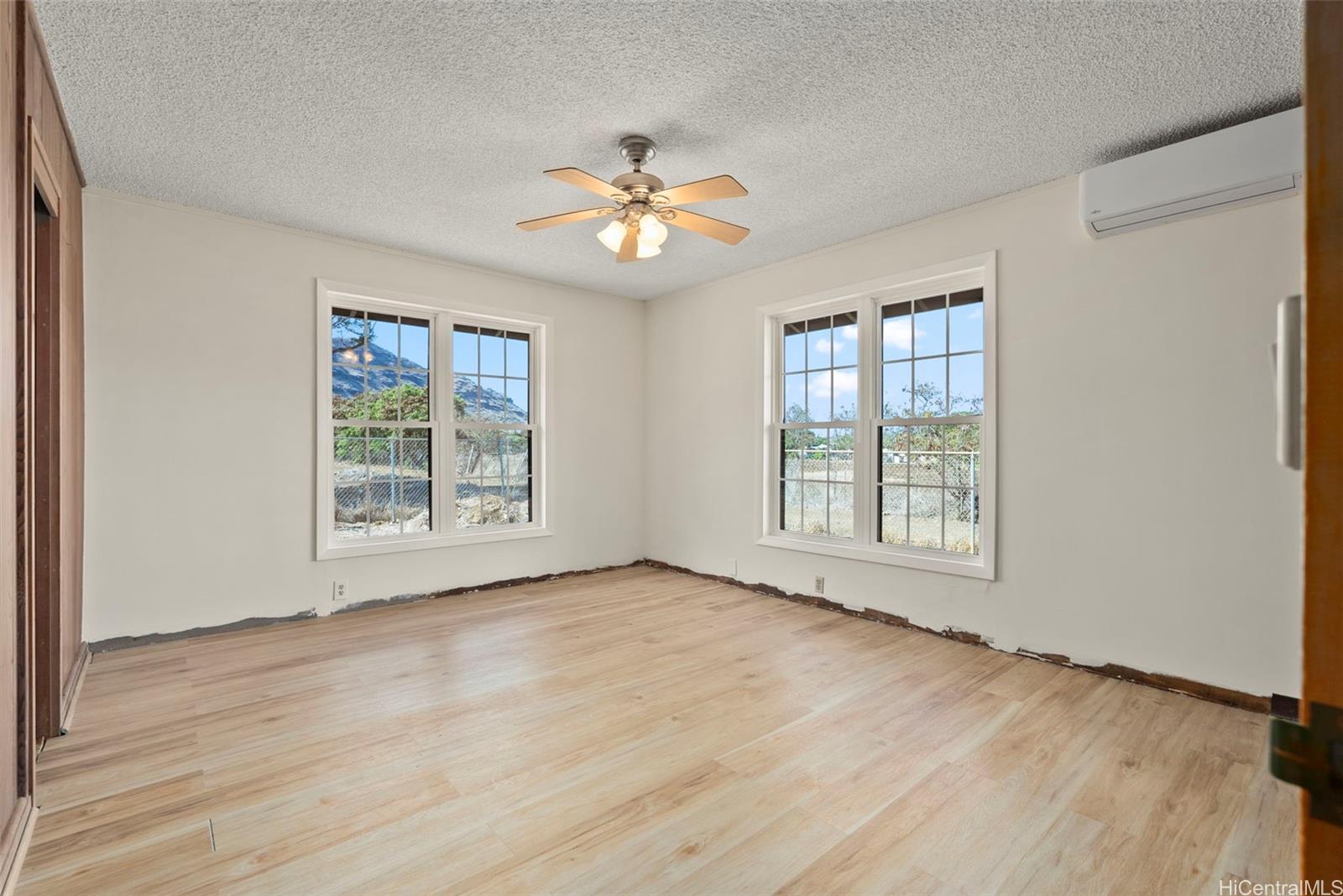 87-1087 Apuupuu Road Waianae, HI 96792 - Photo 9 of 25 a view of an empty room with a window and wooden floor