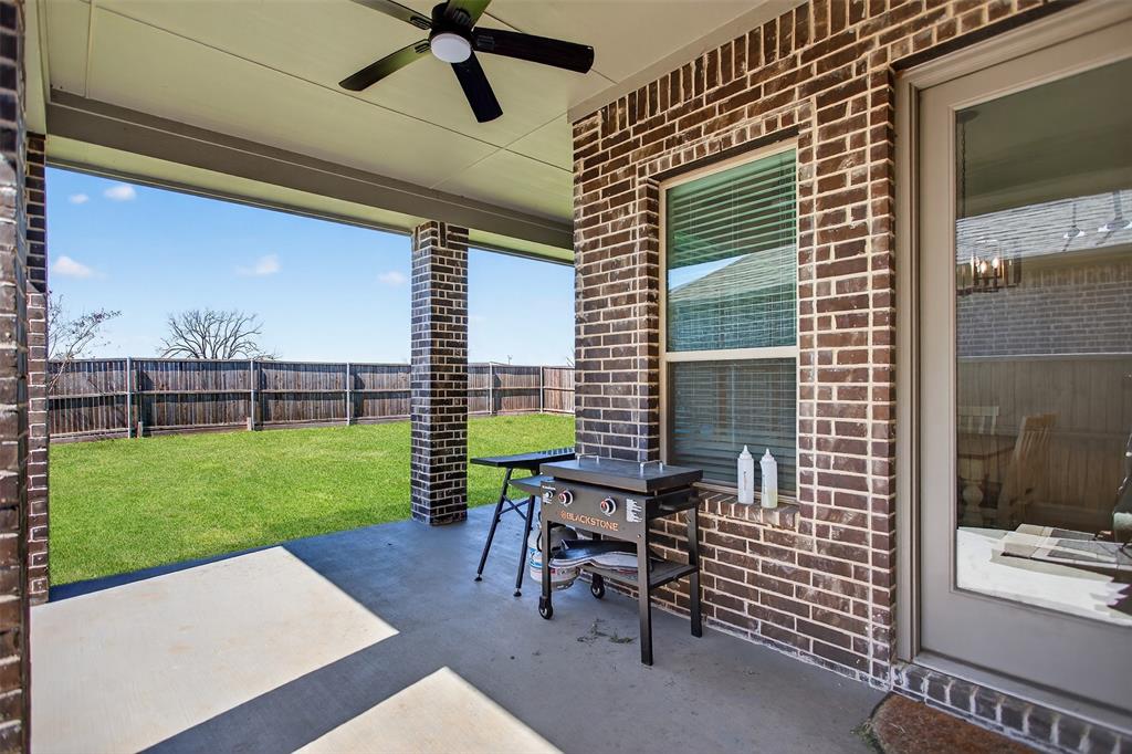 6829 Danridge Road Rowlett, TX 75089 - Photo 19 of 28 a view of a patio with a table and chairs