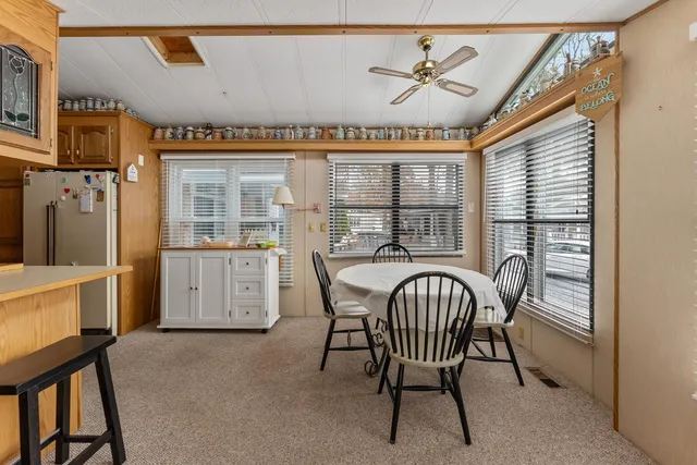 a view of a dining room with furniture and a chandelier