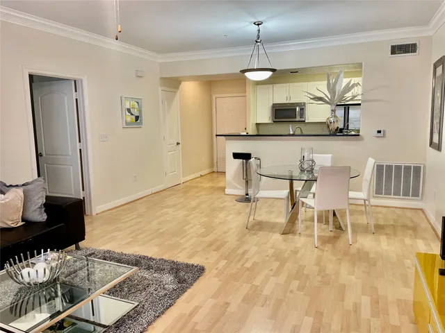 a living room with stainless steel appliances kitchen island granite countertop furniture and rug