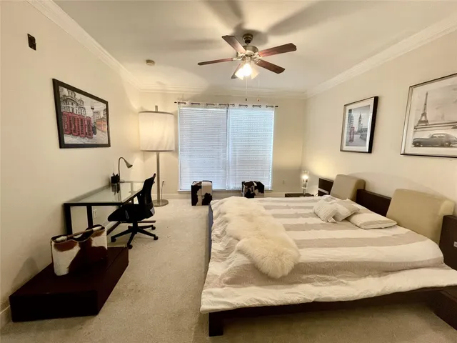 a bedroom with a bed and ceiling fan