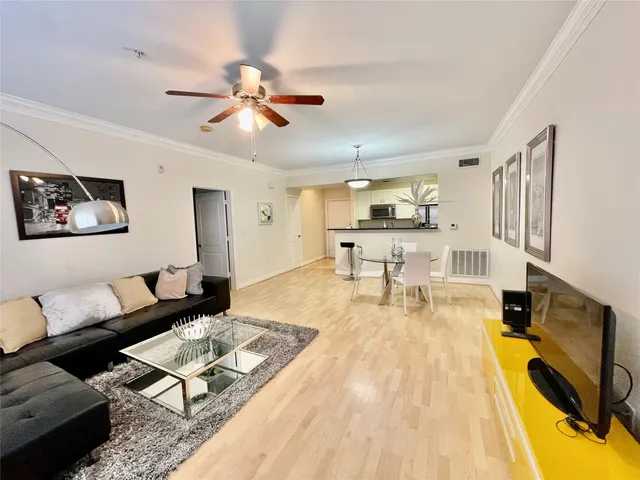 a living room with furniture and kitchen view
