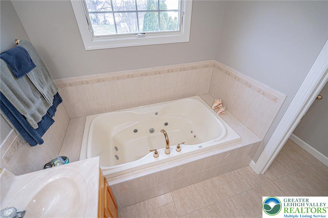 6551 Overlook Road Orefield, PA 18069 - Photo 48 of 82 a bath tub sitting in a bathroom next to a window