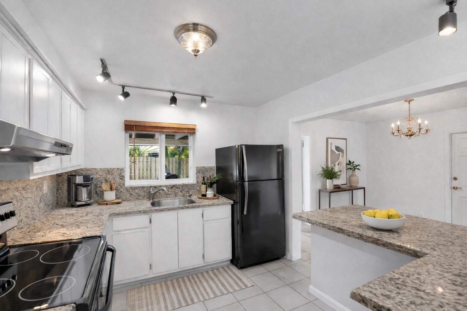 180 Southwest 9th Court Pompano Beach, FL 33060 - Photo 11 of 27 a kitchen with refrigerator and stove
