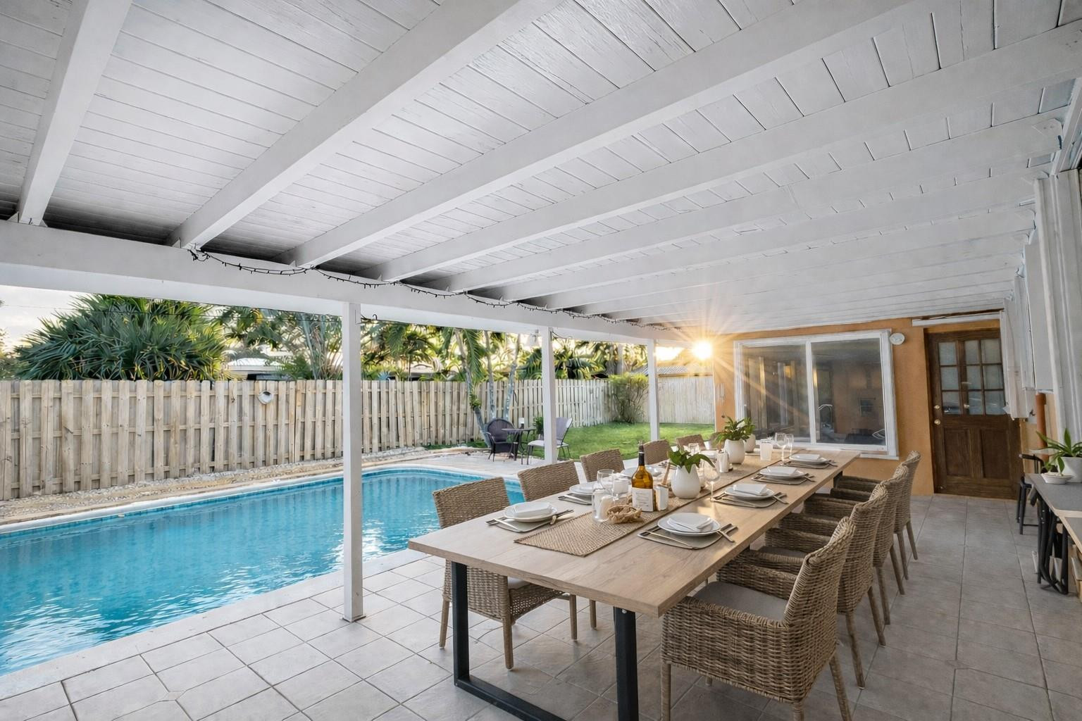 180 Southwest 9th Court Pompano Beach, FL 33060 - Photo 16 of 27 a view of a patio with a table chairs and a small yard