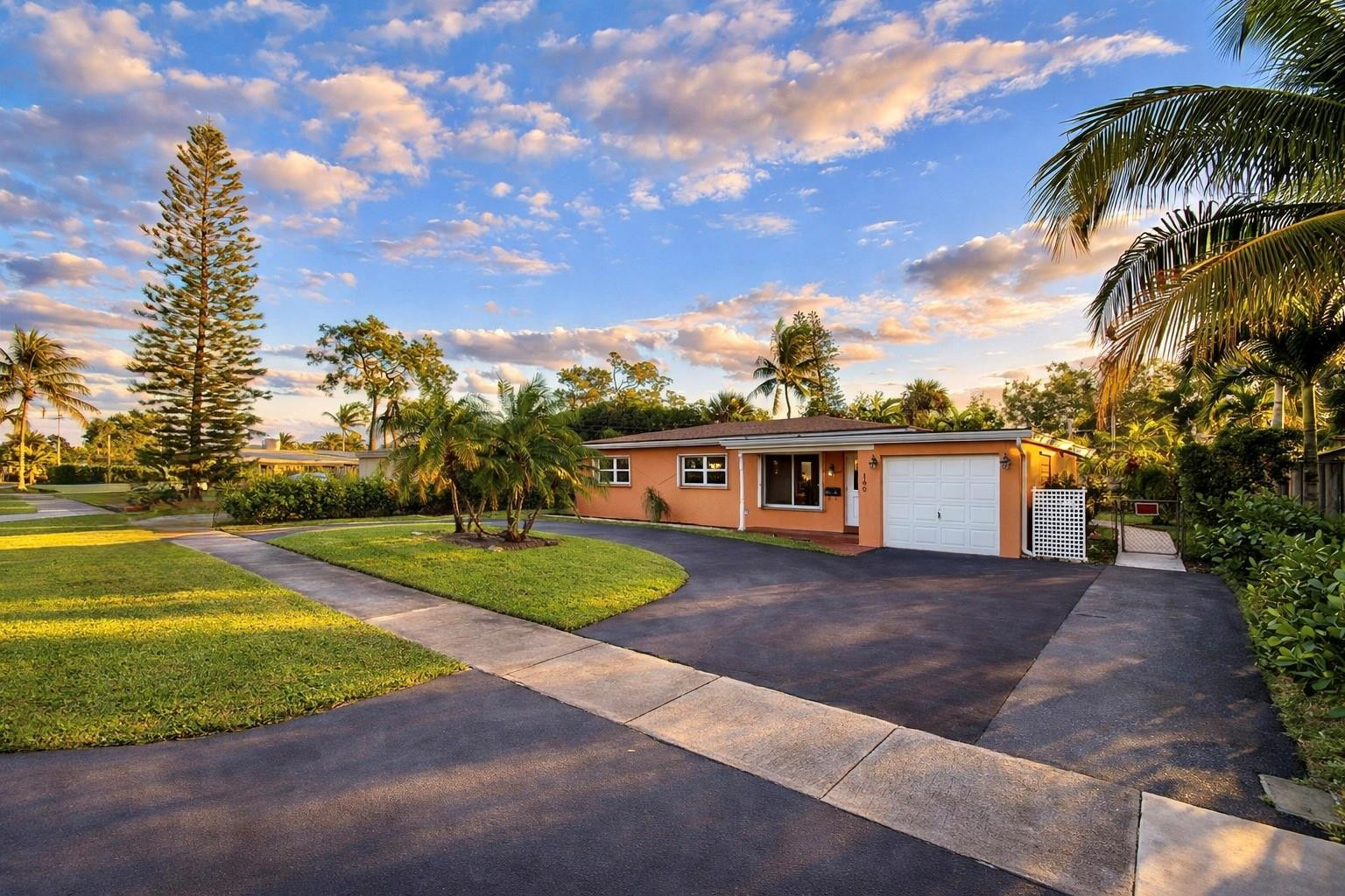 180 Southwest 9th Court Pompano Beach, FL 33060 - Photo 2 of 27 a view of a yard in front of a house with a large tree