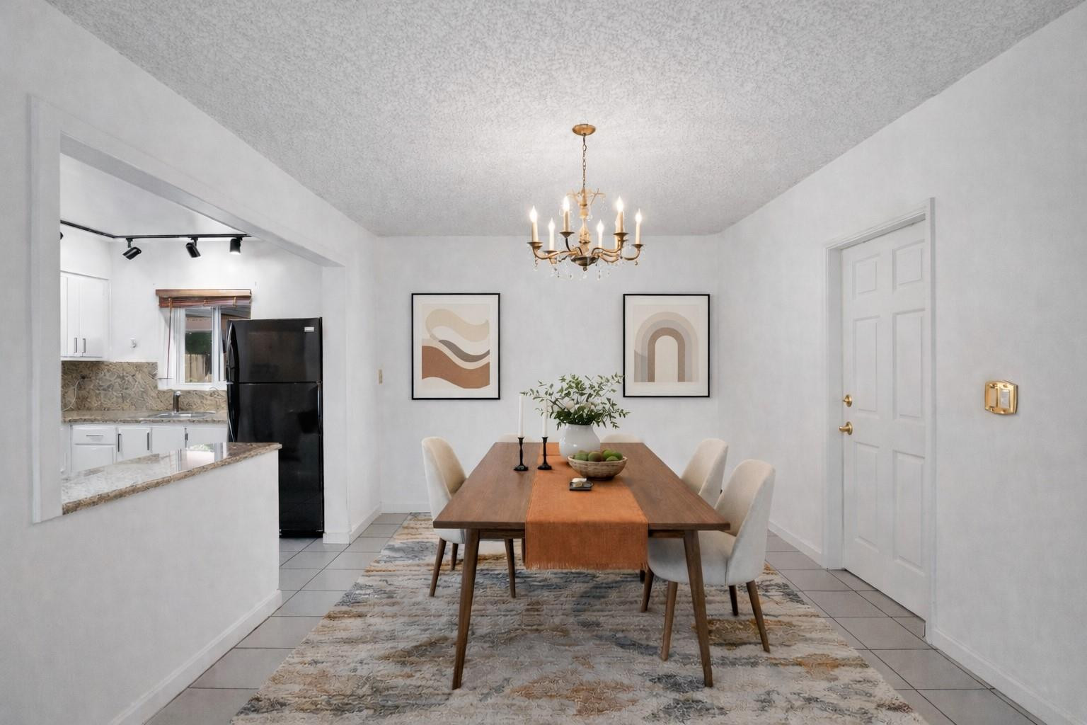 180 Southwest 9th Court Pompano Beach, FL 33060 - Photo 9 of 27 a view of a dining room with furniture and chandelier