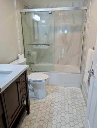 a bathroom with a sink toilet and shower