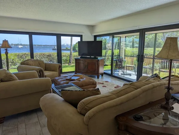 a living room with furniture and a floor to ceiling window