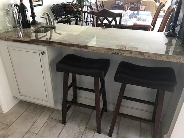 a kitchen with a table chairs and a sink