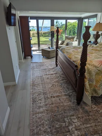 a bed sitting in a bedroom next to a large window