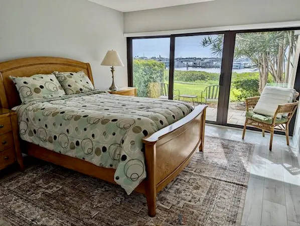 a bed sitting in a bedroom next to a large window