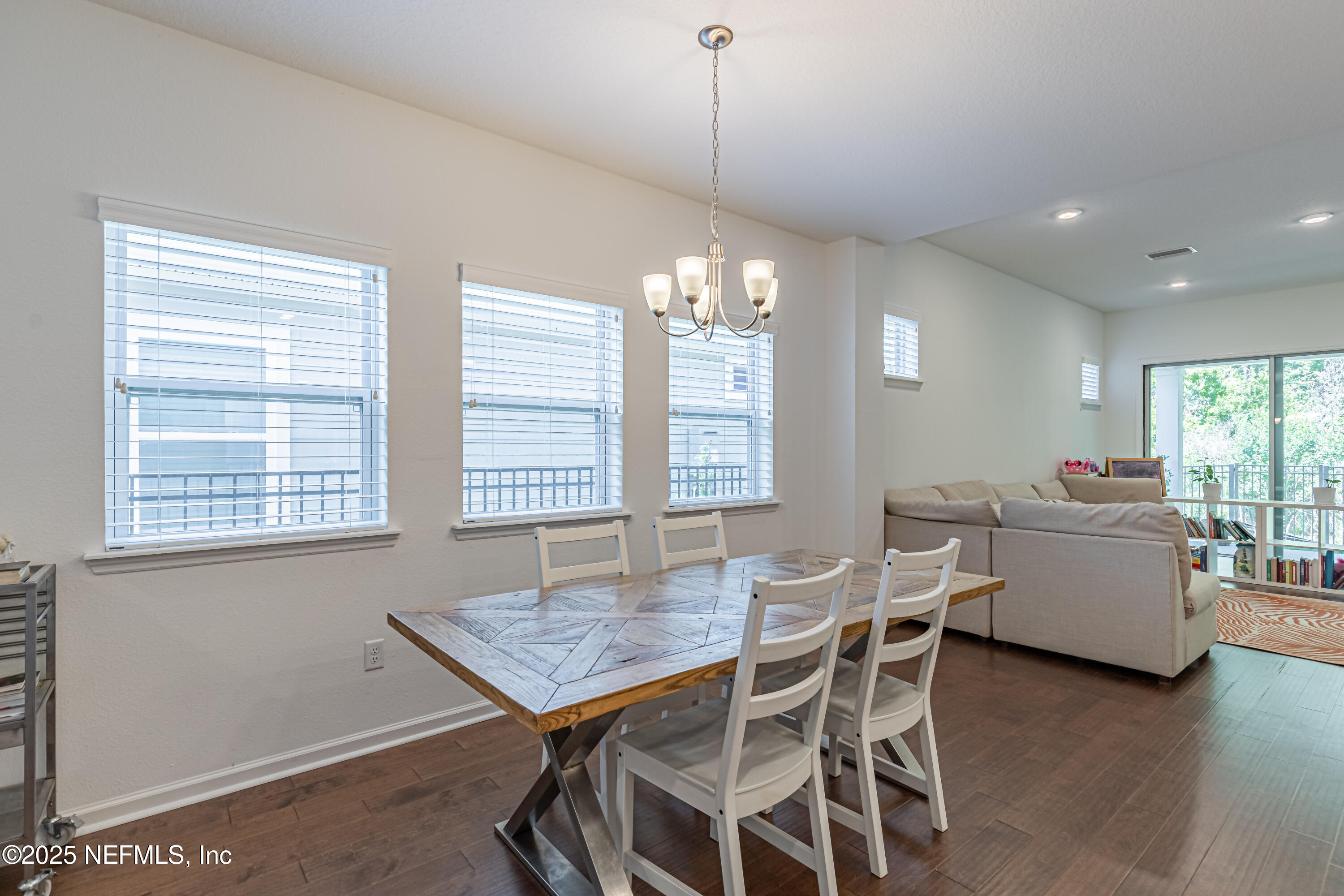 383 Windswept Way Street St. Augustine, FL 32092 - Photo 9 of 34 a view of a dining room with furniture and wooden floor