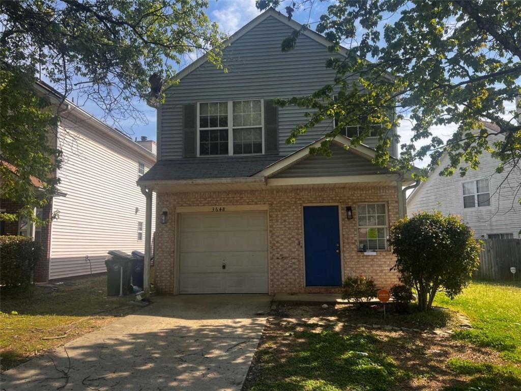 3648 Sapphire Court Decatur, GA 30034 - Photo 2 of 16 a front view of a house with a yard and garage