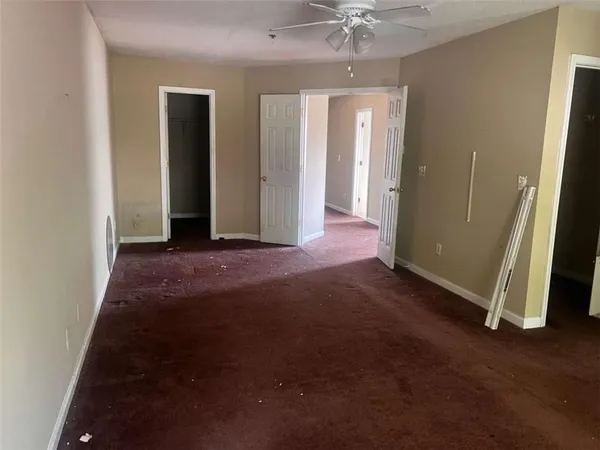 an empty room with windows and entrance