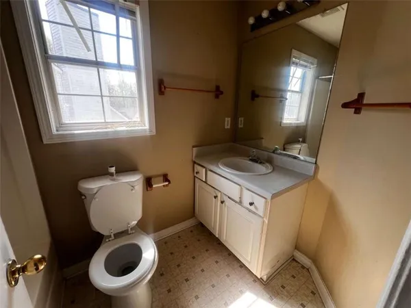 a bathroom with a toilet sink and mirror