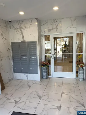 a view of a hallway with table and chairs
