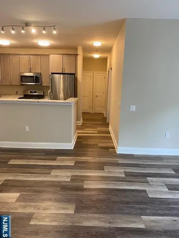 a view of kitchen with cabinets and stainless steel appliances