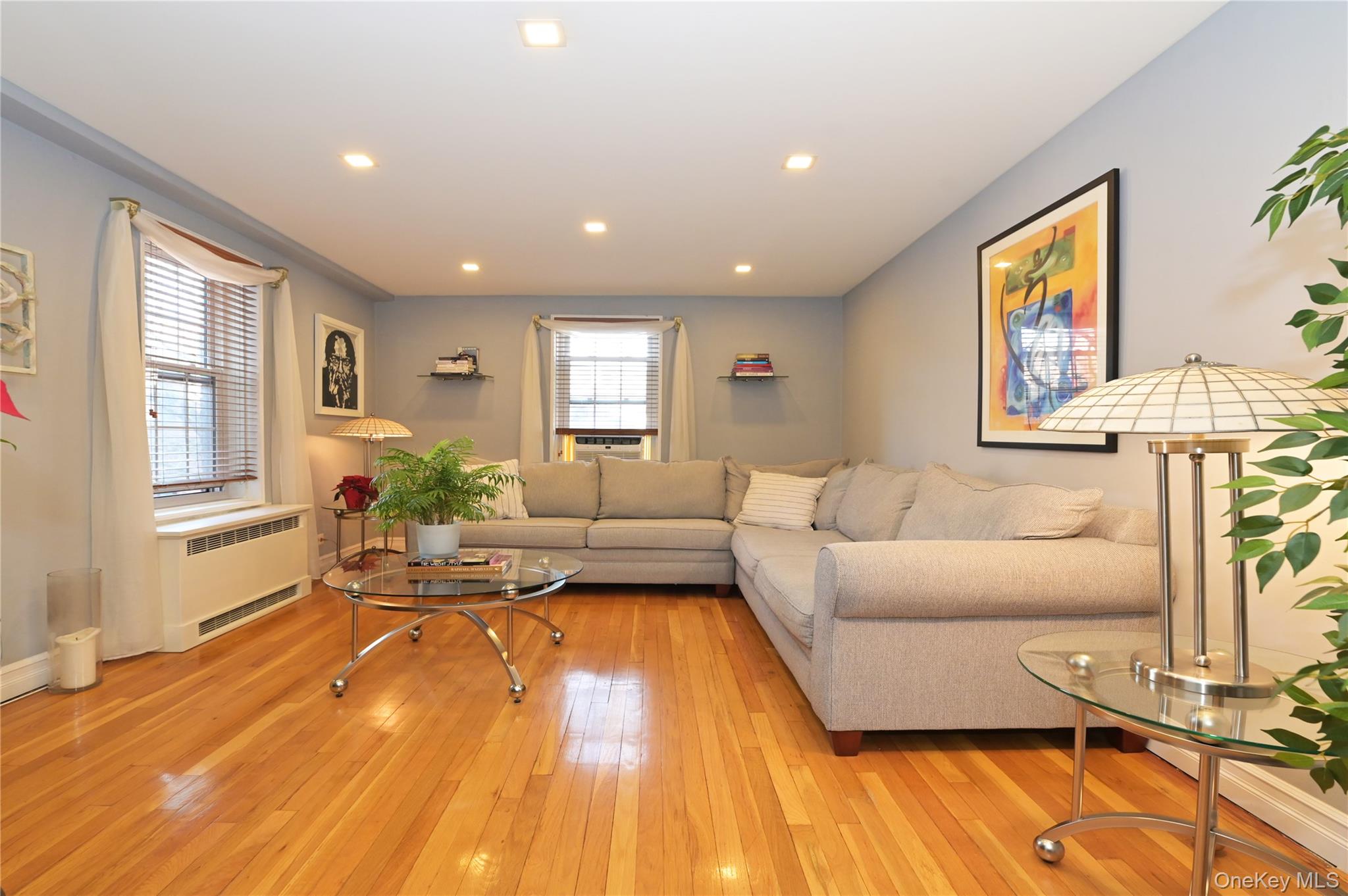 139-09 84th Drive, Unit 306 Queens, NY 11435 - Photo 1 of 12 Living area with radiator, light wood finished floors, and recessed lighting