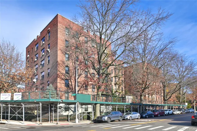 a view of a city street lined with buildings and trees