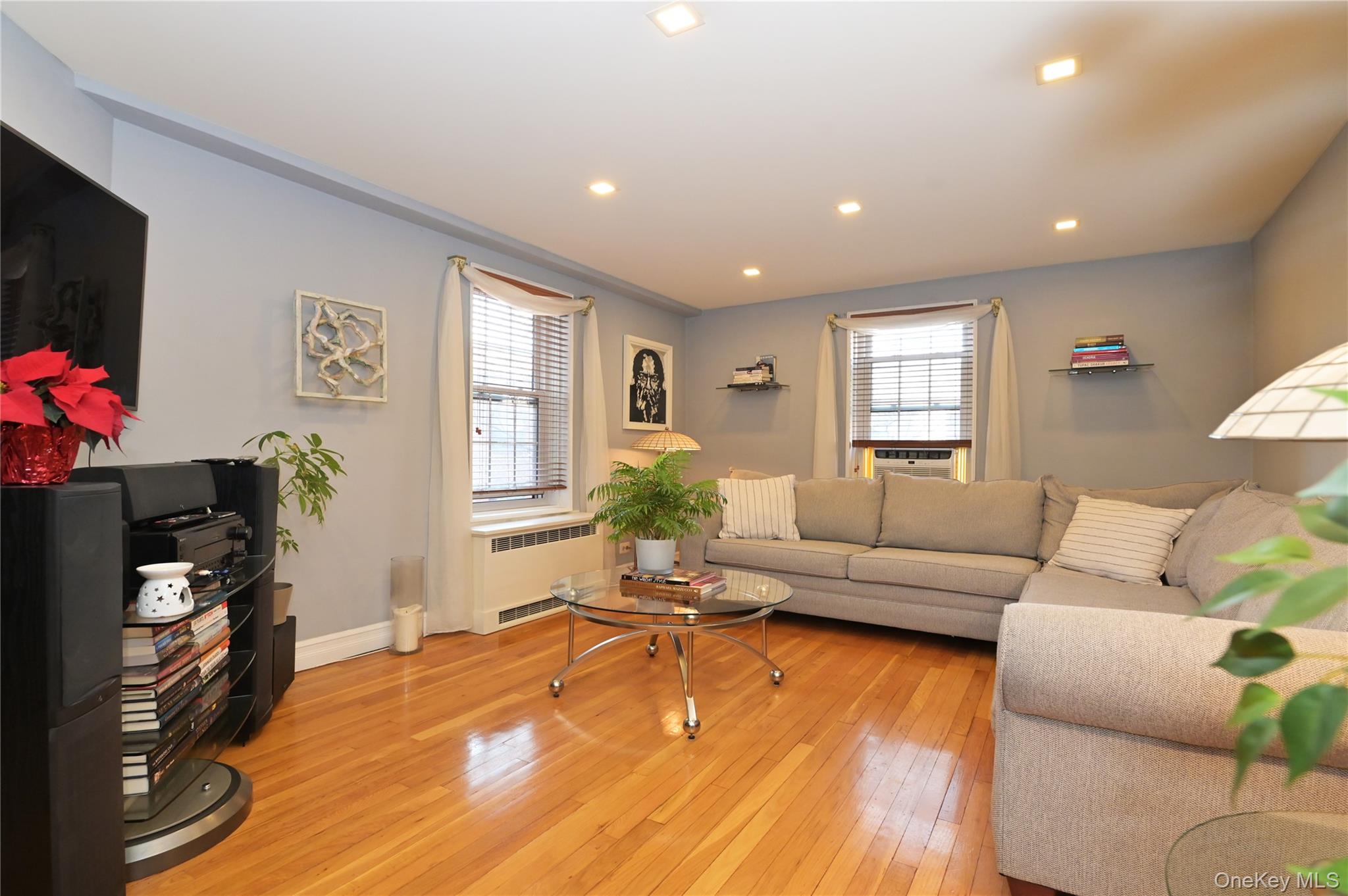 139-09 84th Drive, Unit 306 Queens, NY 11435 - Photo 2 of 12 Living area featuring light wood-style flooring, radiator heating unit, and recessed lighting