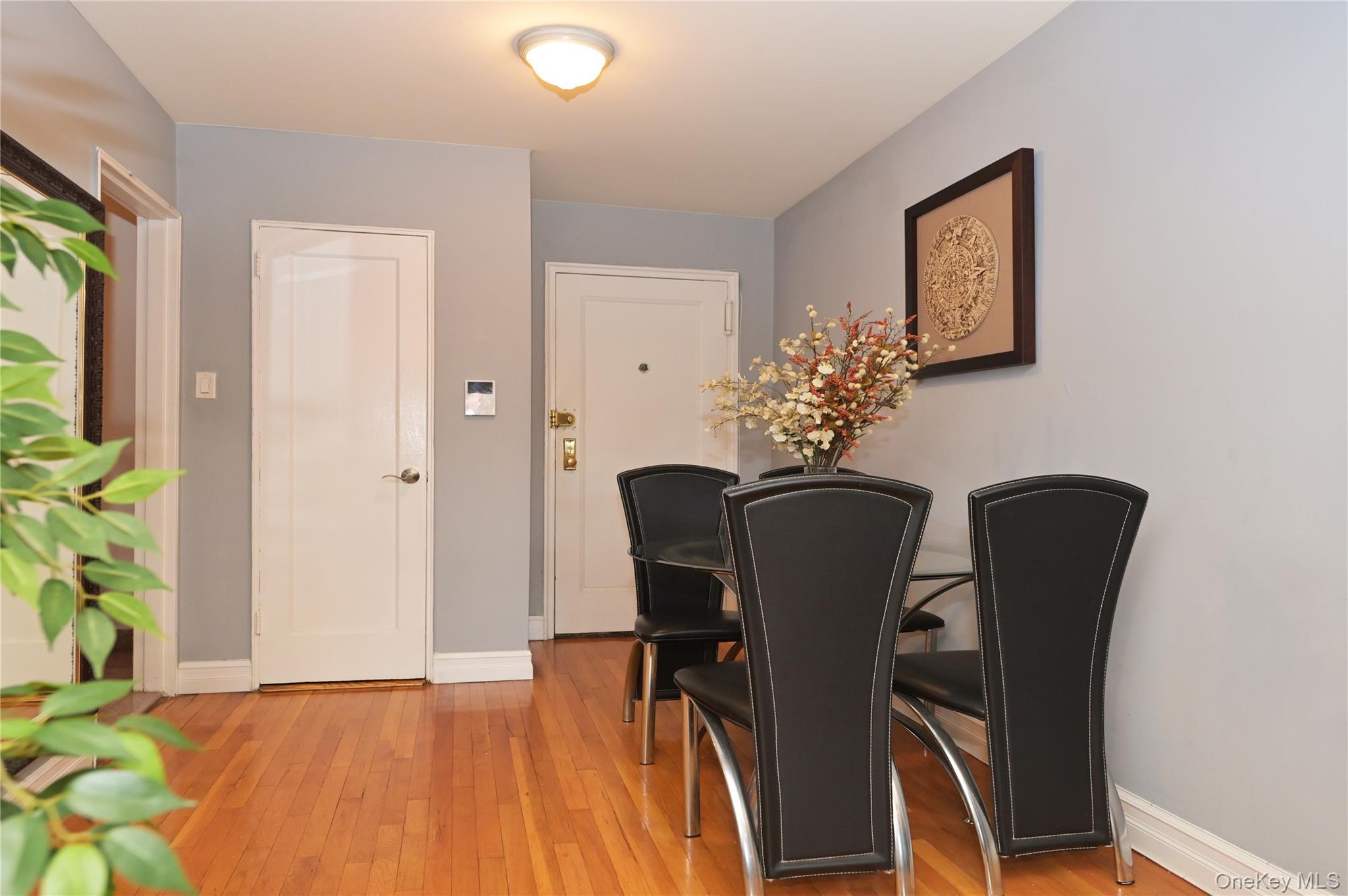 139-09 84th Drive, Unit 306 Queens, NY 11435 - Photo 4 of 12 Dining room with baseboards and light wood-style flooring