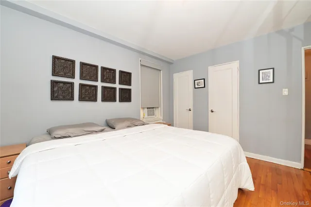 a spacious bedroom with a bed and a window