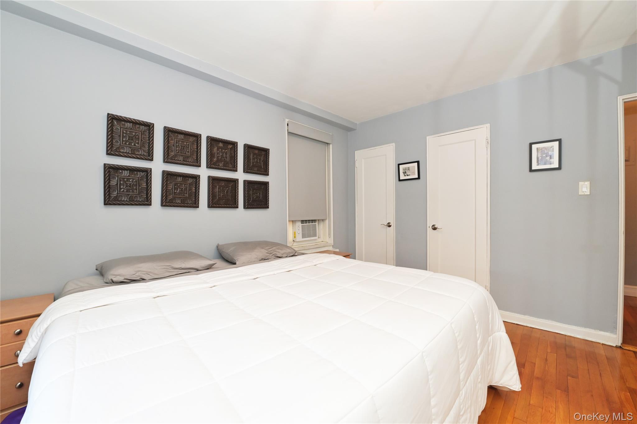 139-09 84th Drive, Unit 306 Queens, NY 11435 - Photo 8 of 12 Bedroom featuring wood-type flooring and two closets