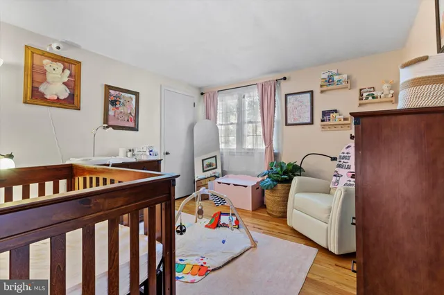 a bedroom with furniture and a book shelf