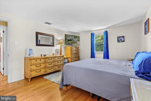 a bed room with a bed and a dresser