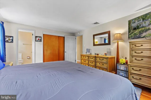 a bedroom with a bed and dresser