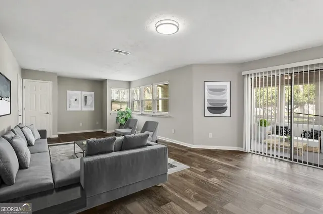 a living room with furniture and a window with balcony view