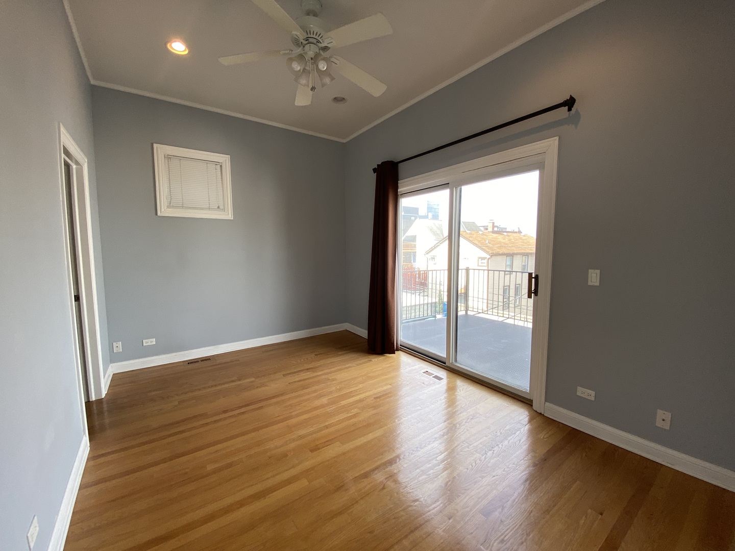 Undisclosed Address Chicago, IL 60613 - Photo 5 of 10 a view of an empty room with wooden floor and a window