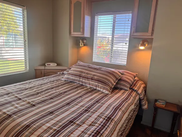 a bedroom with a bed and a window