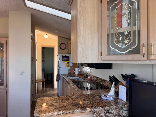 a kitchen with a refrigerator and a stove