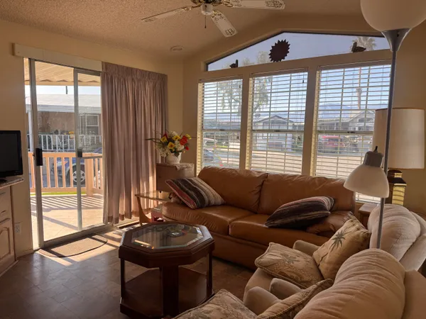 a living room with furniture and a floor to ceiling window