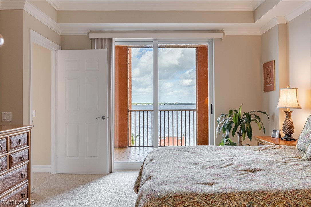 2743 First Street, Unit 602 Fort Myers, FL 33916 - Photo 16 of 38 a bed sitting in a bedroom next to a window